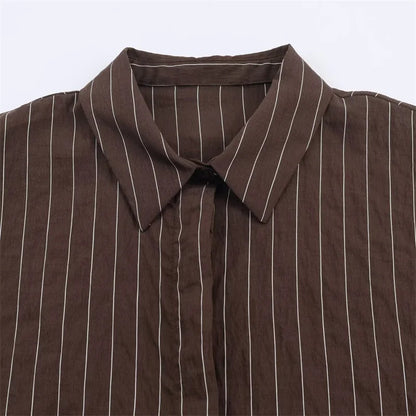 A women’s brown shirt in the “old money” aesthetic embodies quiet luxury and understated refinement. Typically crafted from high-quality fabrics like silk, fine cotton, or linen, it features a clean, tailored silhouette