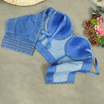 A denim corset with hanging rhinestones strikes a bold balance between rugged edge and high-glam allure. The structured denim hugs the body, giving it that classic, sculpted silhouette, while the cascading rhinestones add mov
