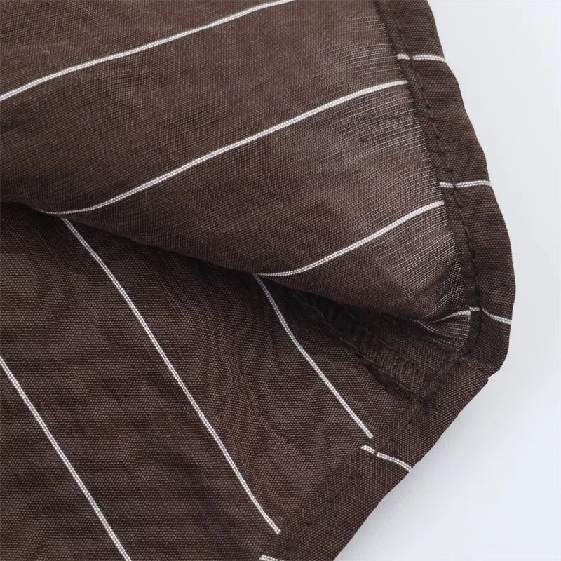 A women’s brown shirt in the “old money” aesthetic embodies quiet luxury and understated refinement. Typically crafted from high-quality fabrics like silk, fine cotton, or linen, it features a clean, tailored silhouette