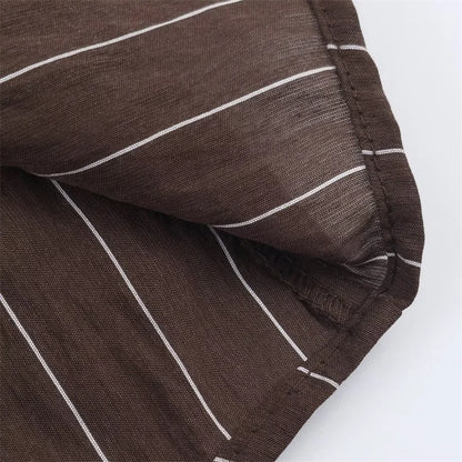 A women’s brown shirt in the “old money” aesthetic embodies quiet luxury and understated refinement. Typically crafted from high-quality fabrics like silk, fine cotton, or linen, it features a clean, tailored silhouette