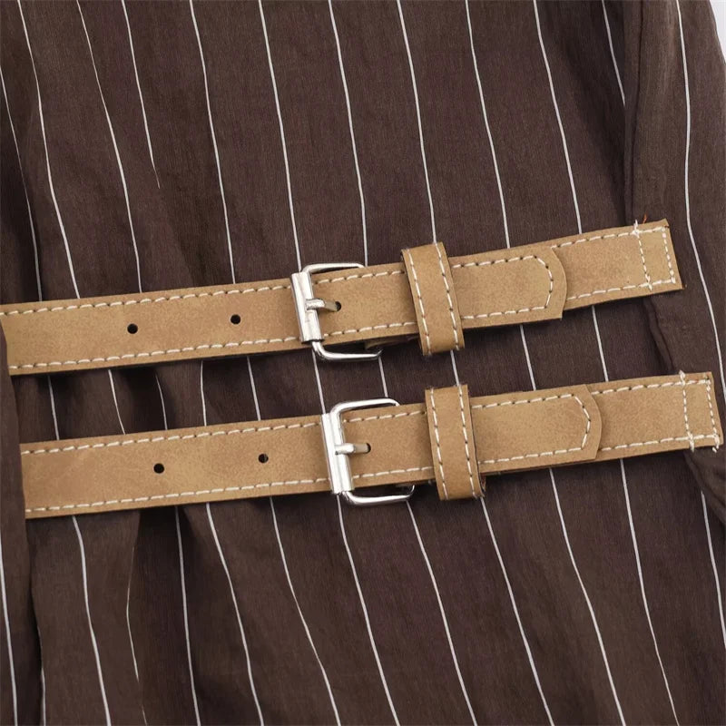 A women’s brown shirt in the “old money” aesthetic embodies quiet luxury and understated refinement. Typically crafted from high-quality fabrics like silk, fine cotton, or linen, it features a clean, tailored silhouette