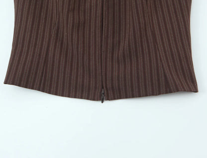 A brown vest paired with high-waisted brown pants creates a sleek, monochromatic look that feels both polished and effortlessly refined. The vest adds a tailored, structured edge—especially when worn fitted or slightly crop