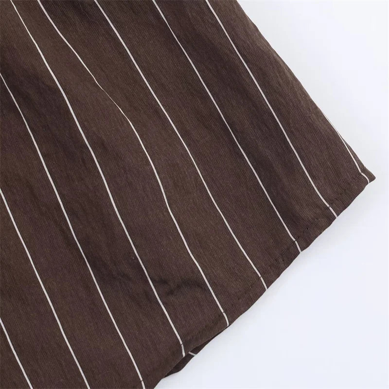 A women’s brown shirt in the “old money” aesthetic embodies quiet luxury and understated refinement. Typically crafted from high-quality fabrics like silk, fine cotton, or linen, it features a clean, tailored silhouette