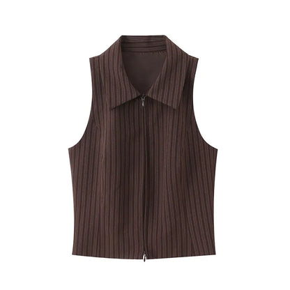 A brown vest paired with high-waisted brown pants creates a sleek, monochromatic look that feels both polished and effortlessly refined. The vest adds a tailored, structured edge—especially when worn fitted or slightly crop