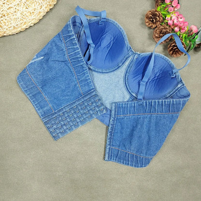 A denim corset with hanging rhinestones strikes a bold balance between rugged edge and high-glam allure. The structured denim hugs the body, giving it that classic, sculpted silhouette, while the cascading rhinestones add mov