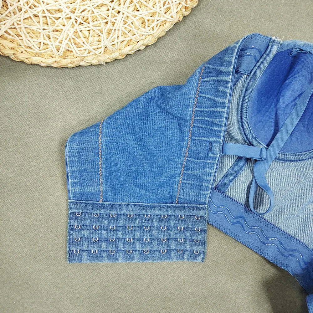 A denim corset with hanging rhinestones strikes a bold balance between rugged edge and high-glam allure. The structured denim hugs the body, giving it that classic, sculpted silhouette, while the cascading rhinestones add mov