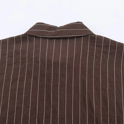 A women’s brown shirt in the “old money” aesthetic embodies quiet luxury and understated refinement. Typically crafted from high-quality fabrics like silk, fine cotton, or linen, it features a clean, tailored silhouette