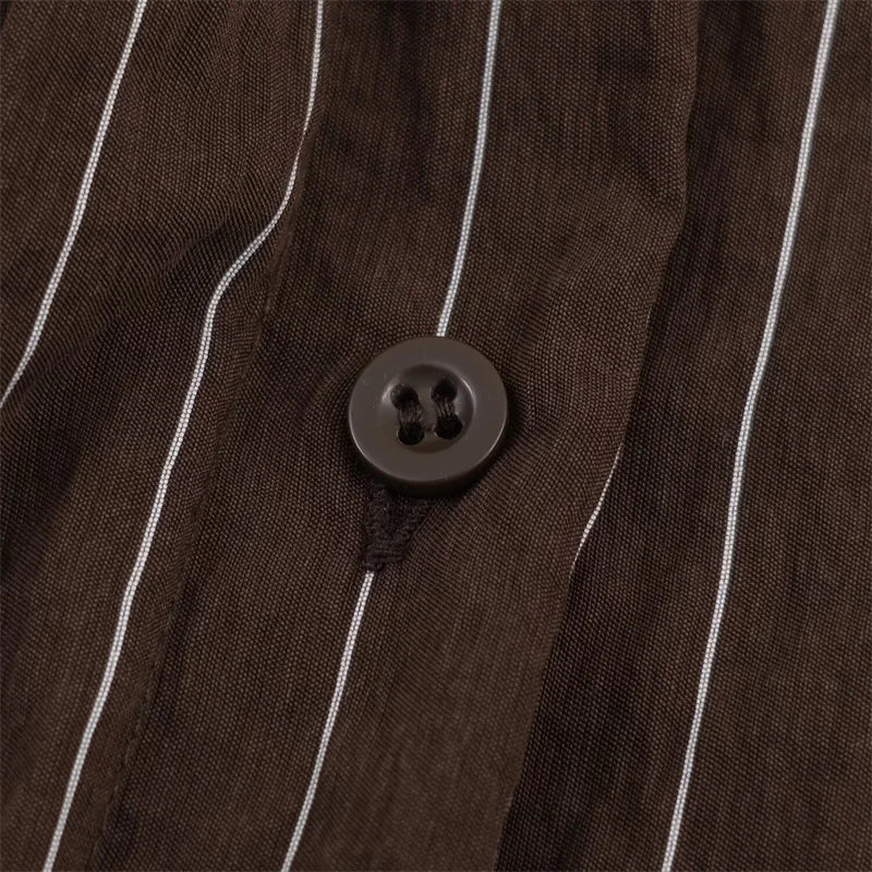 A women’s brown shirt in the “old money” aesthetic embodies quiet luxury and understated refinement. Typically crafted from high-quality fabrics like silk, fine cotton, or linen, it features a clean, tailored silhouette