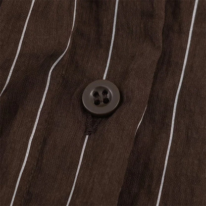 A women’s brown shirt in the “old money” aesthetic embodies quiet luxury and understated refinement. Typically crafted from high-quality fabrics like silk, fine cotton, or linen, it features a clean, tailored silhouette