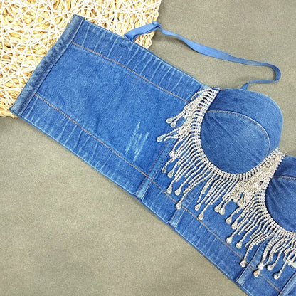 A denim corset with hanging rhinestones strikes a bold balance between rugged edge and high-glam allure. The structured denim hugs the body, giving it that classic, sculpted silhouette, while the cascading rhinestones add mov